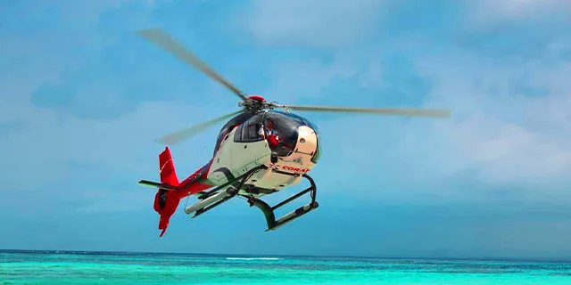 Helicopter flying above the turquoise Mauritius coast